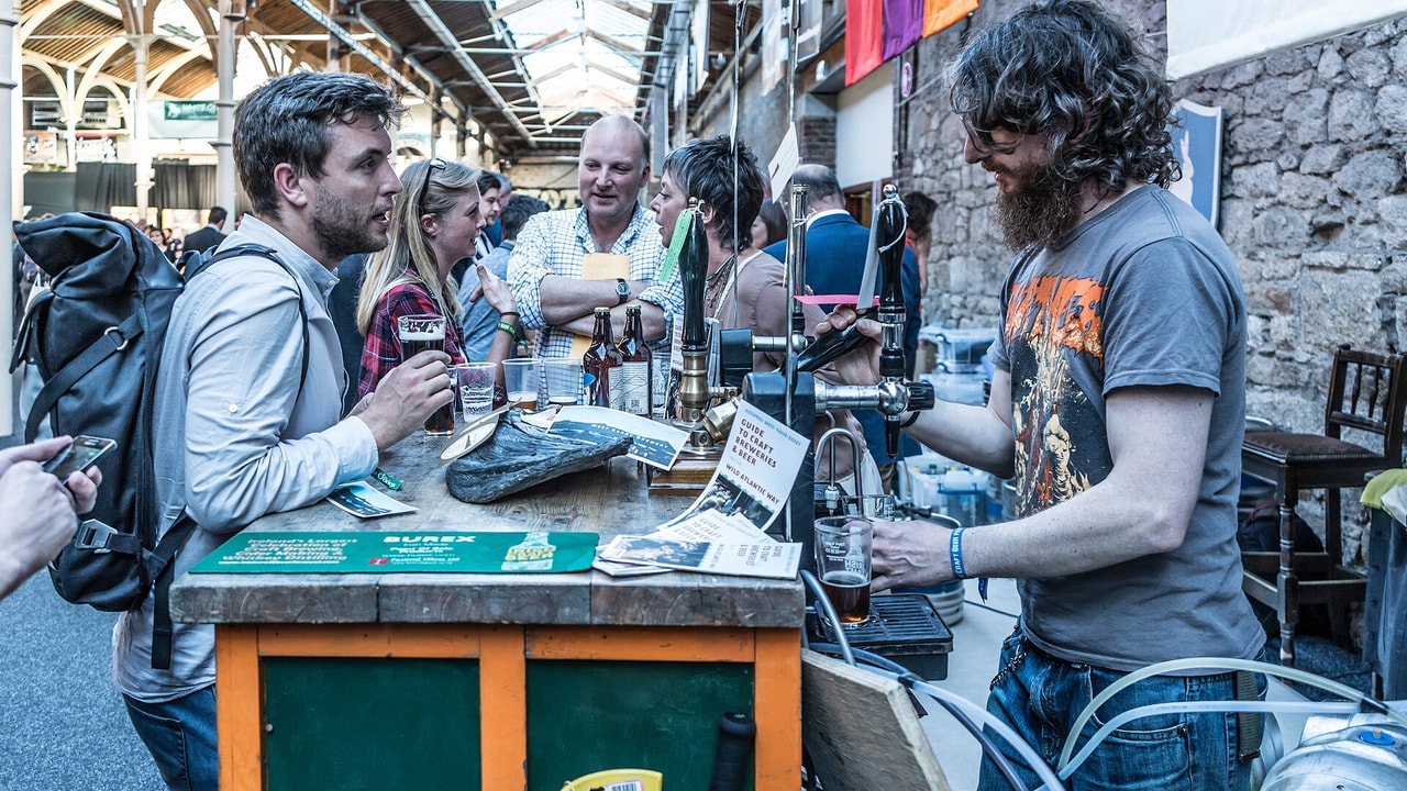 A brewer serves attendees at the Irish Craft Beer Festival in the RDS, Dublin.