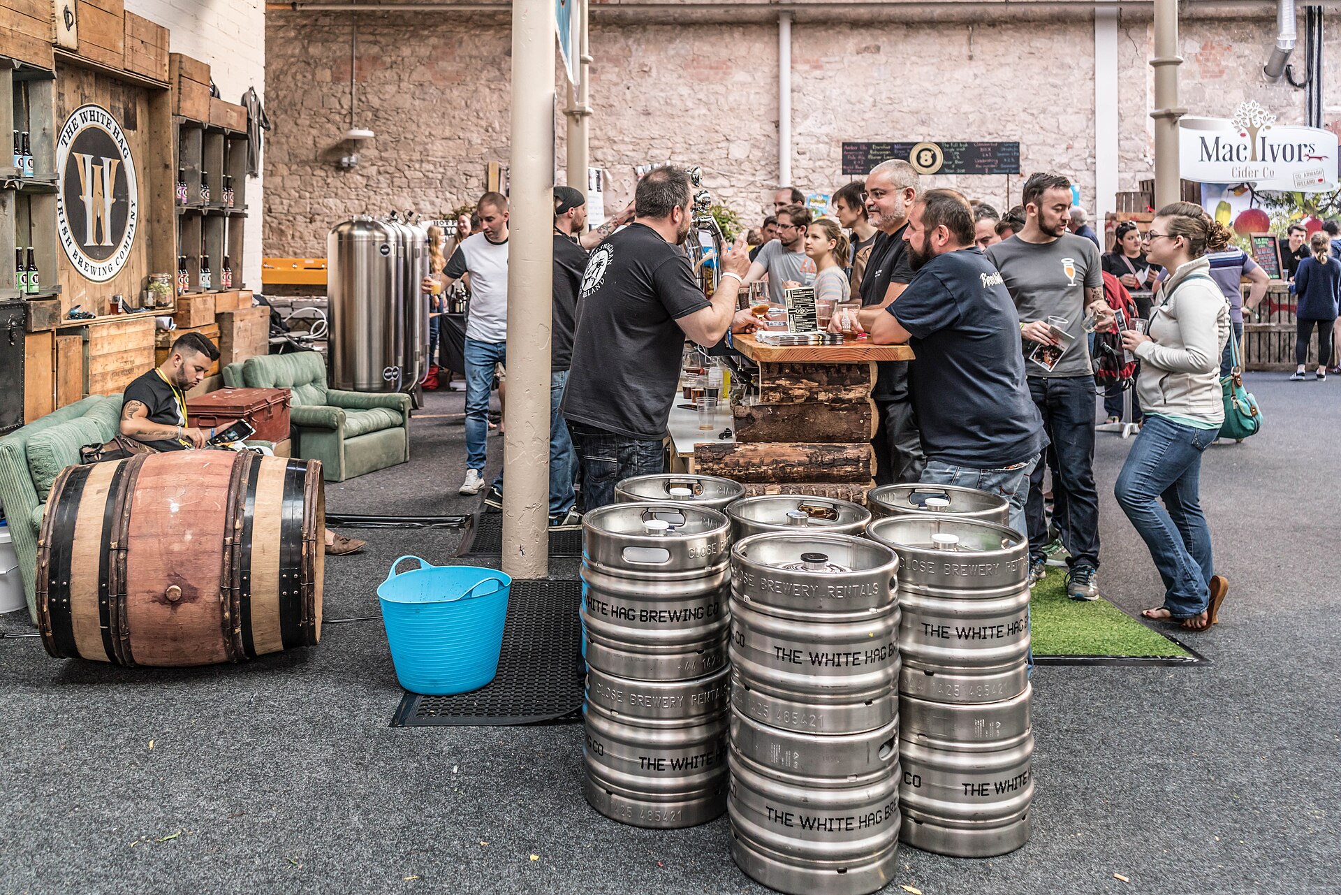 Festival guests gathering around beer barrels and tasting stands