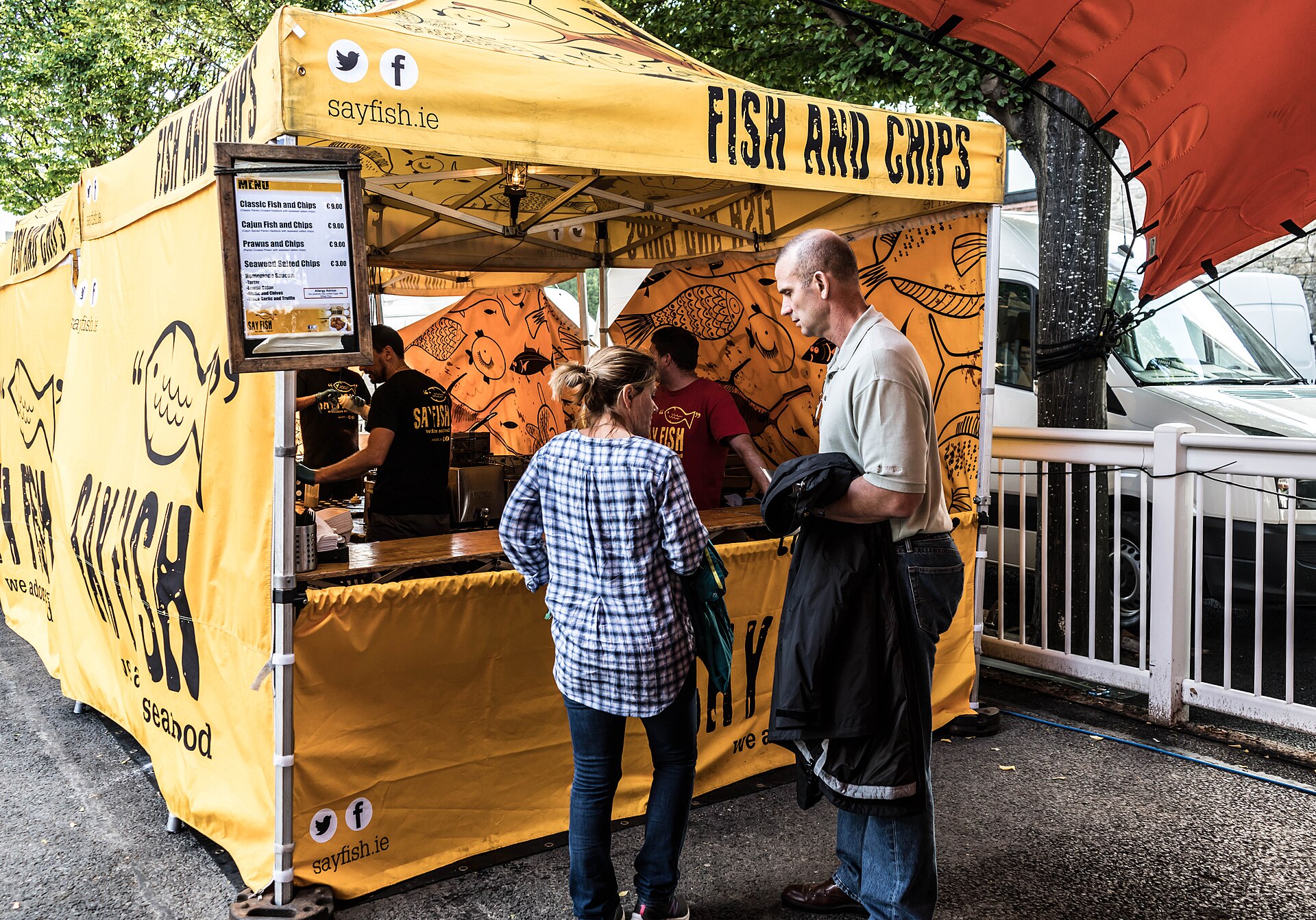 Guests ordering food beside the beer stands at an outdoor festival