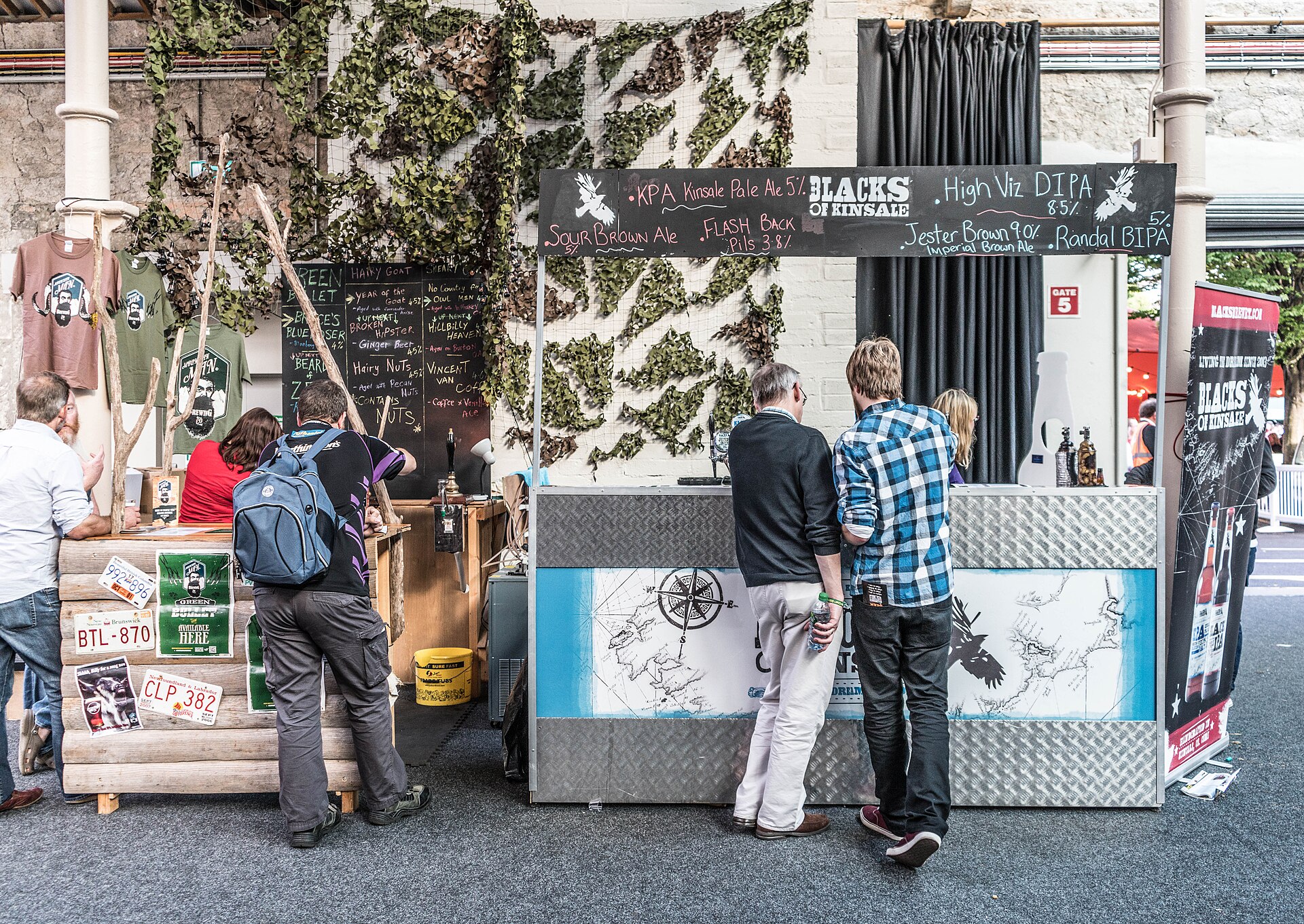 Guests visiting a craft beer stand at an outdoor festival