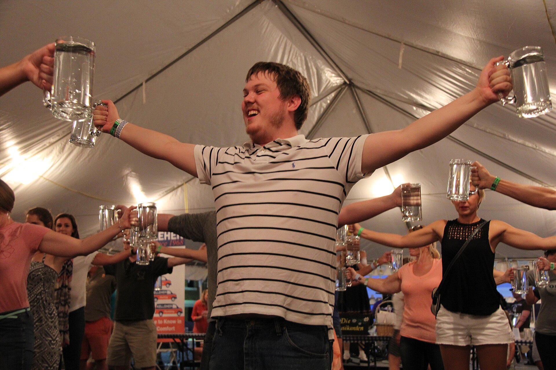 Friends raising empty steins together at an Oktoberfest celebration