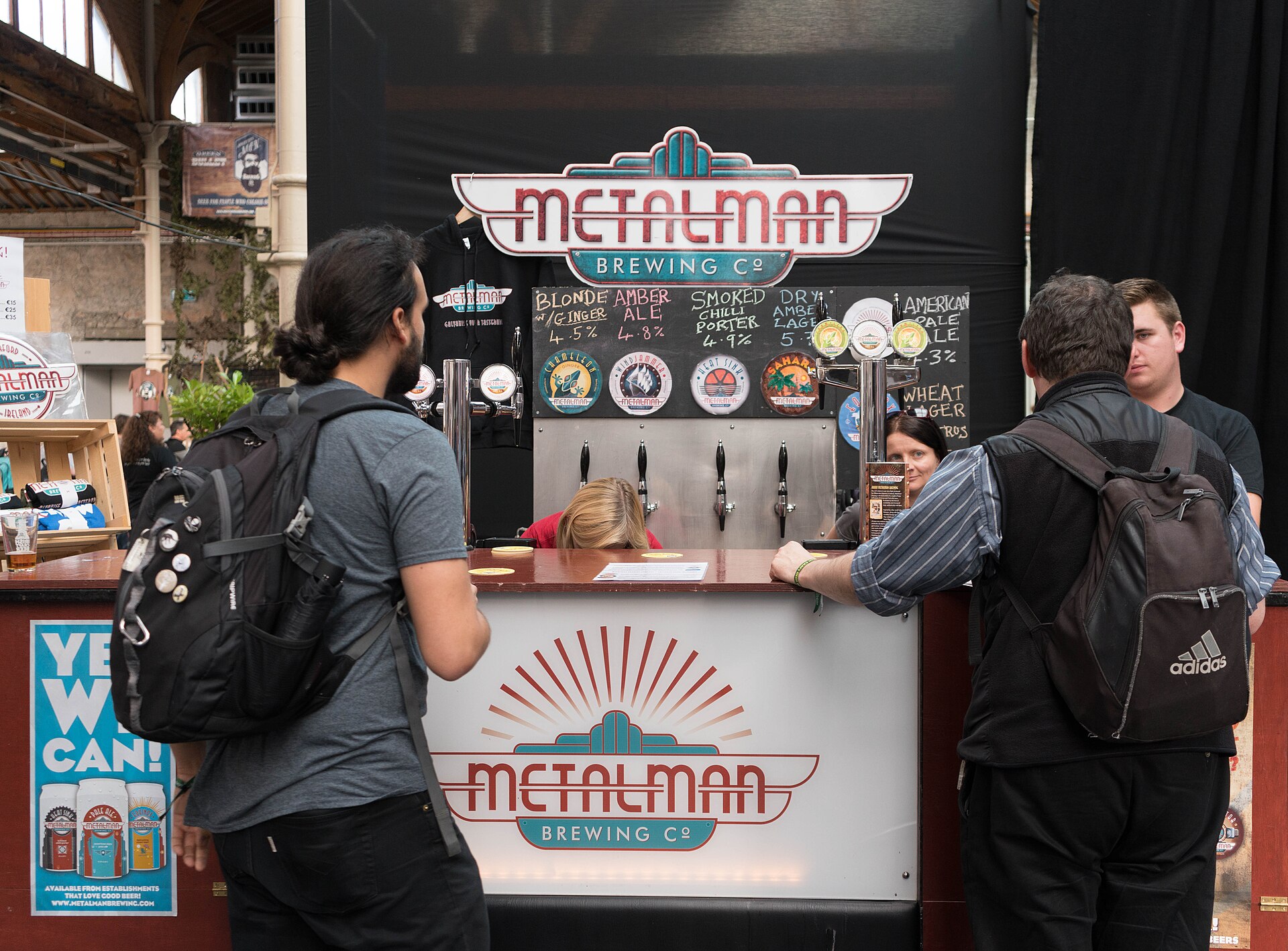 Brewers pouring samples for guests at a craft beer festival