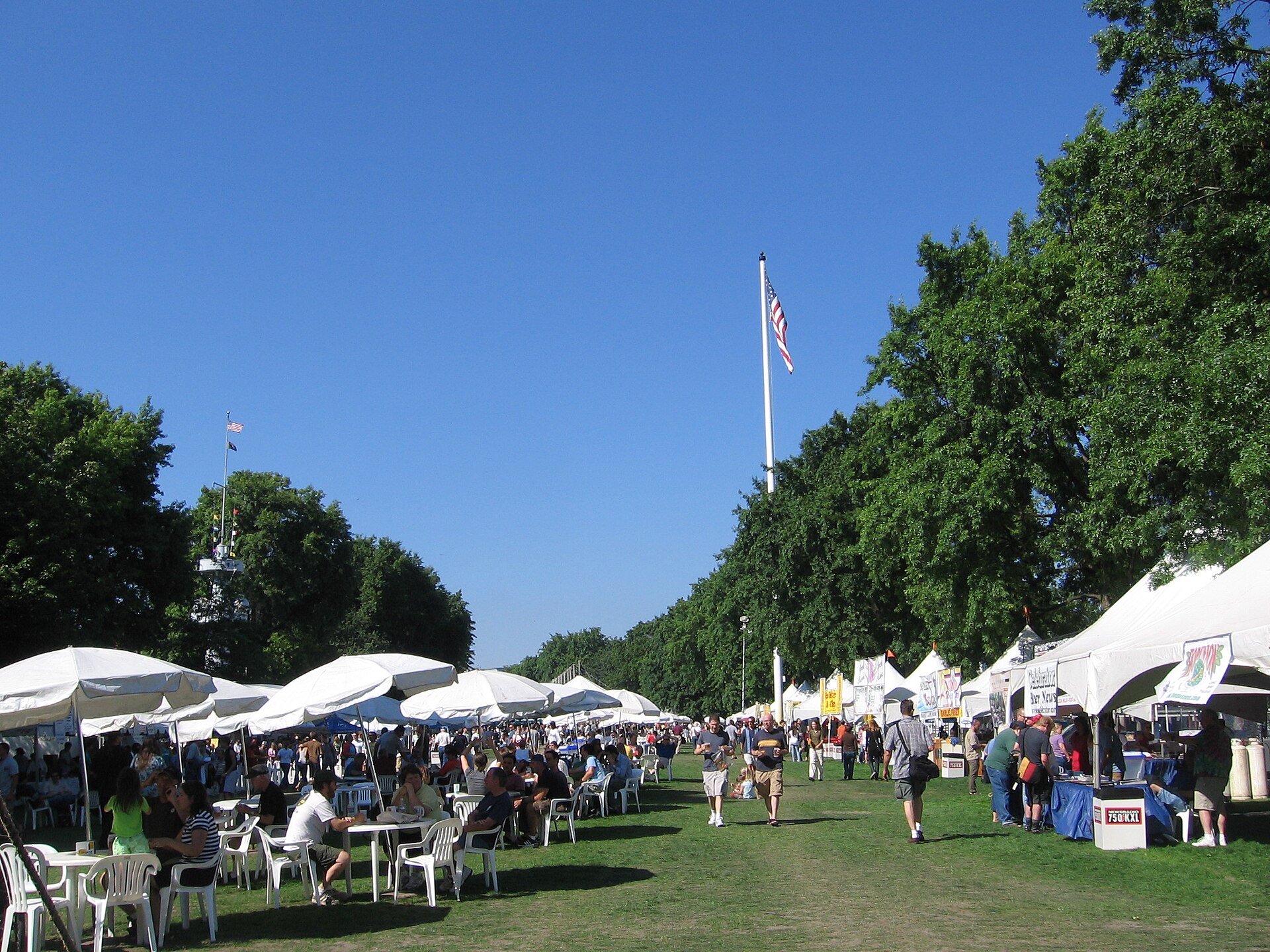 Crowds browsing brewery tents at an outdoor Oregon beer festival