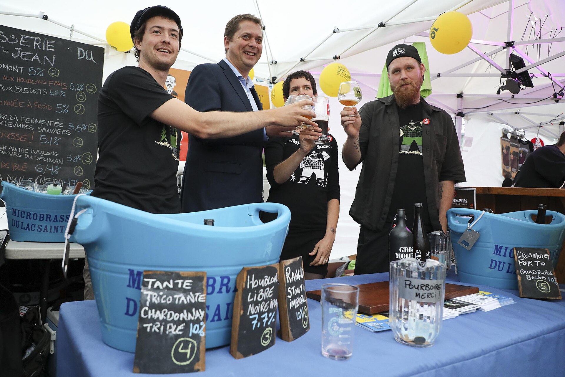 Brewers and guests sharing samples at a Canadian beer festival