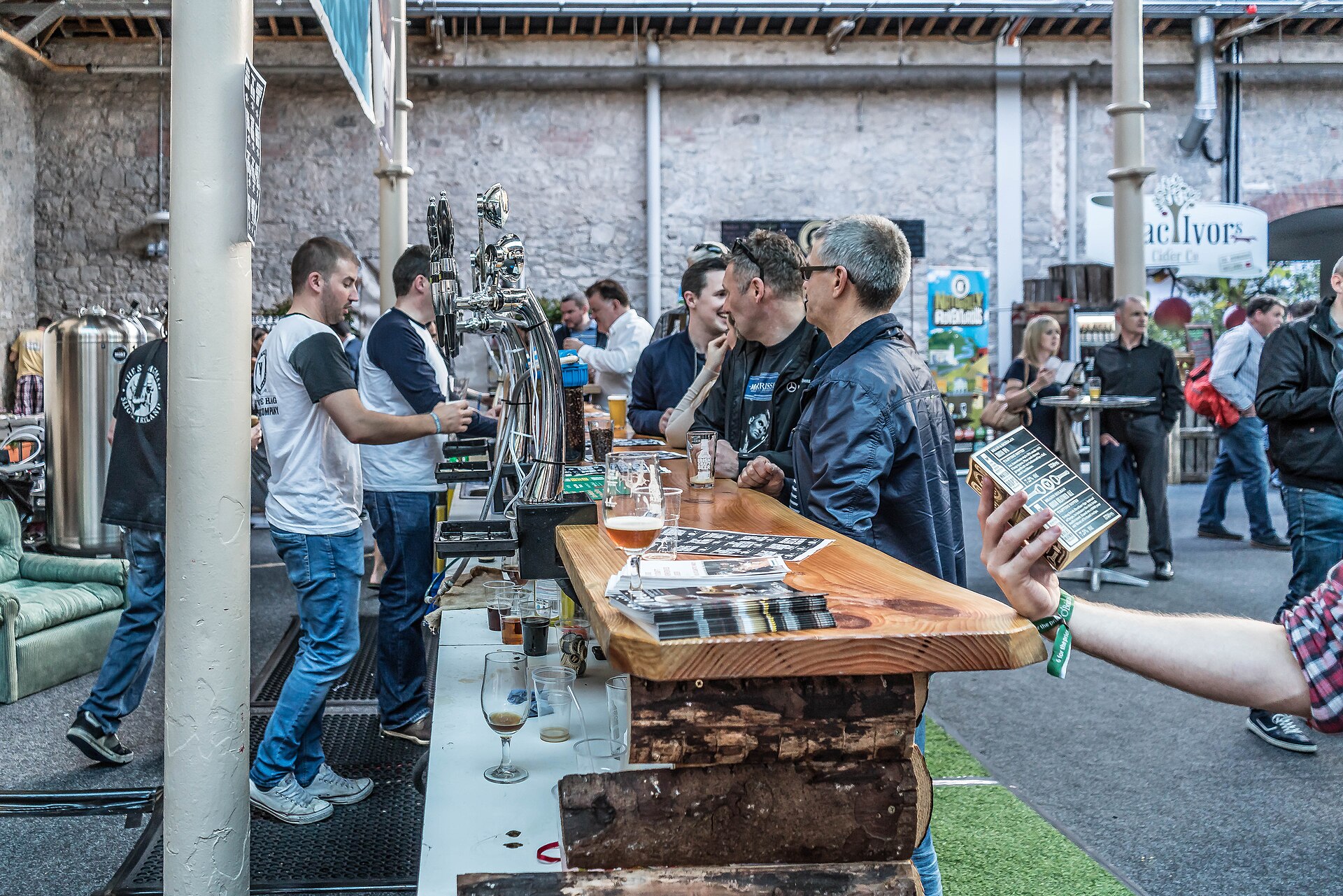 Guests chatting with producers at an outdoor craft beer festival