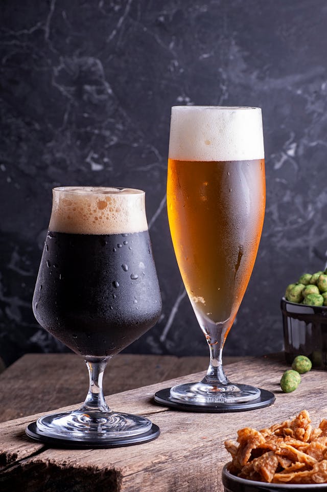 Two elegant beer glasses showcasing different beer styles with professional lighting